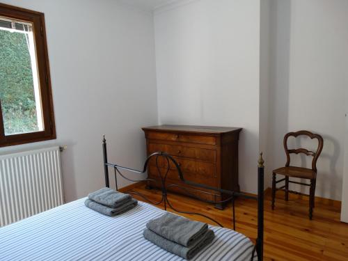 サン・テティエンヌにあるLe Clos Gentianeのベッドルーム1室(ベッド1台、ドレッサー、椅子付)
