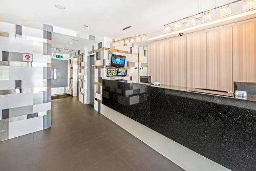 a lobby of a hospital with black and white tiles at Hotel 81 Selegie in Singapore