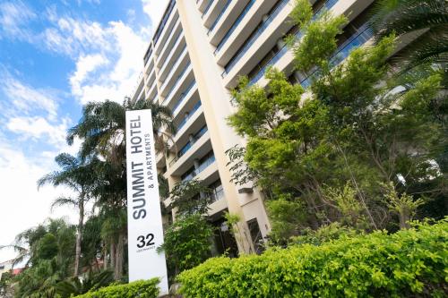 a tall building with a sign in front of it at Summit Apartments Brisbane City in Brisbane