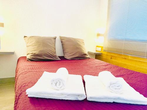 a bedroom with a bed with two towels on it at Appartement Cap Estivales in Cap d'Agde