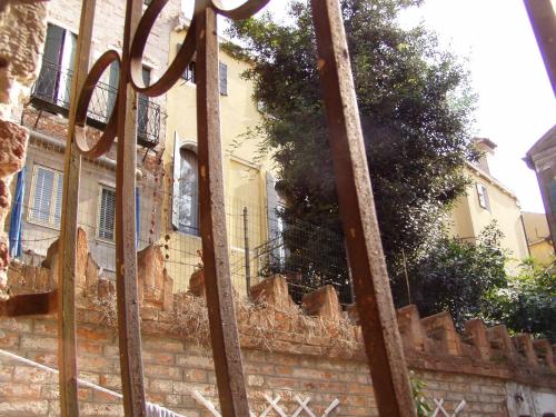 an old brick building with a fence in front of it at b&b allo squero in Venice