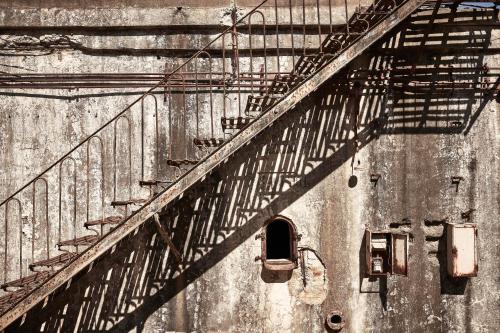 a black and white photo of a building with stairs at Dexamenes Seaside Hotel in Kourouta