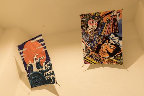 two pieces of art hanging on a wall at Guesthouse Raku in Kyoto