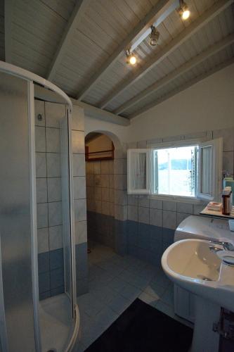 a bathroom with a shower and a sink at Fisherman's Cottage in Kalamakia