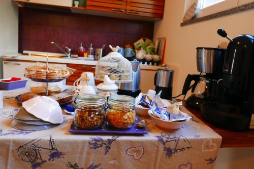 a table with jars of food on it in a kitchen at B&B Ai Tre Archi in Spotorno