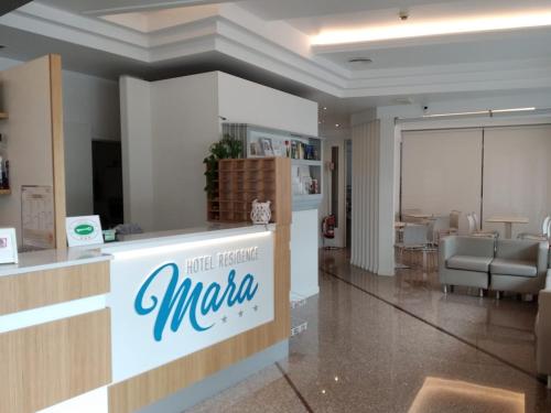 a lobby with a mazda sign on a counter at Hotel Residence Mara in Lido di Jesolo