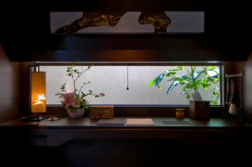 a fish tank with plants and a lamp on a desk at Narada Resort & Spa Perfume Bay Sanya - All Villas in Lingshui