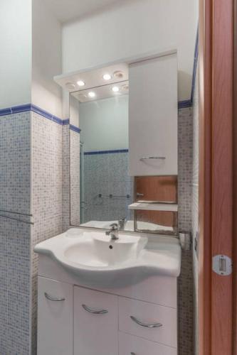 a bathroom with a white sink and a mirror at Casa Vacanze Kamarina in Punta Secca