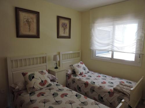 Postel nebo postele na pokoji v ubytování Palm Beach