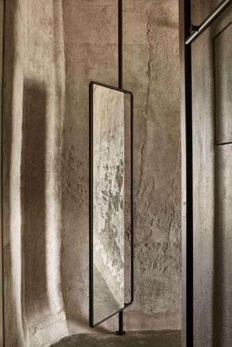 a mirror hanging on a wall in a room at Dexamenes Seaside Hotel in Kourouta