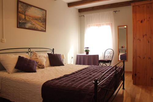 a bedroom with a bed and a table and a window at Apartment Milan Istra in Režanci