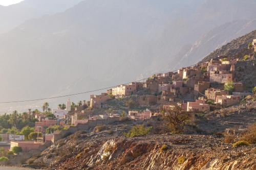 a village on a hill with houses on it at iskki-asnfou in Tafraoute