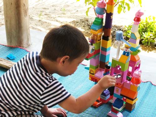 a young boy playing with a lego tower at Kadjan villa in Arugam Bay