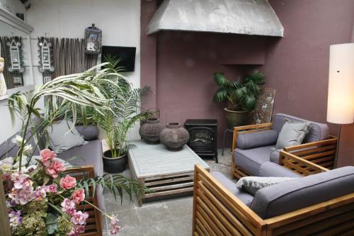 a living room with a couch and a table with plants at DownTown46 in Bergen op Zoom