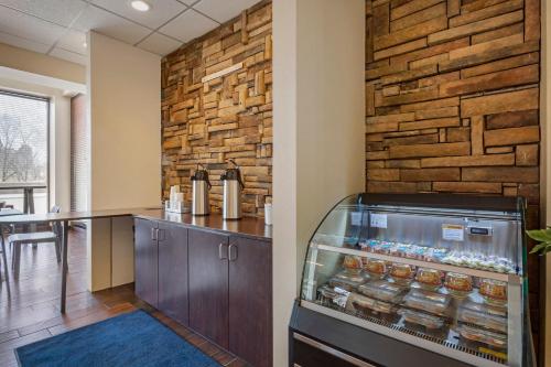 a refrigerator in a room with a brick wall at The Capitol Hotel in Hartford