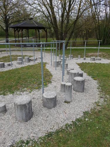 a park with concrete pillars and a gazebo at Kurhotel Anders in Bad Füssing