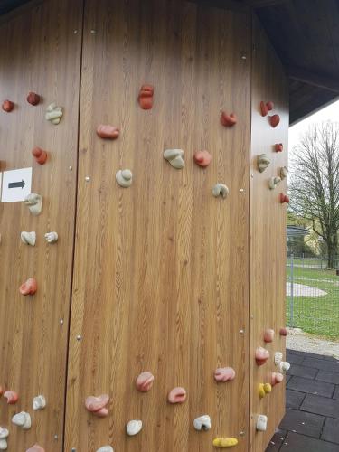 a climbing wall with rocks on the side of it at Kurhotel Anders in Bad Füssing