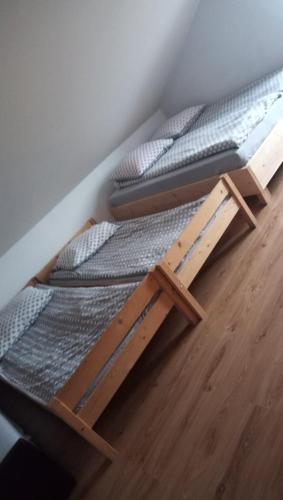 two bunk beds in a room with a wooden floor at Pokoje u Juroszka in Istebna