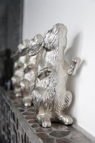 a silver statue of a dog sitting on a counter at DysArt Boutique Hotel - Solar Power in Cape Town