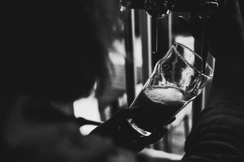 a woman is holding a glass of wine at Kings Arms Hotel in Melrose