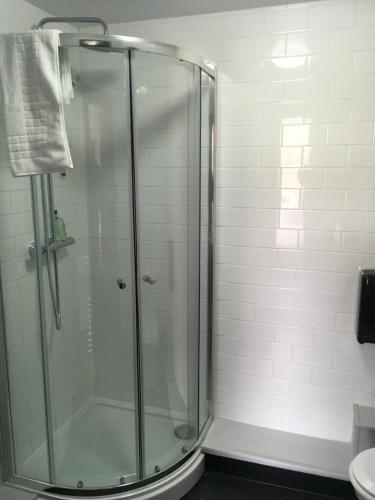 a shower with a glass door in a bathroom at Kings Arms Hotel in Melrose