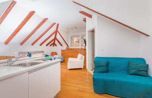 a kitchen with a sink and a living room at Apartments Feri in Dubrovnik