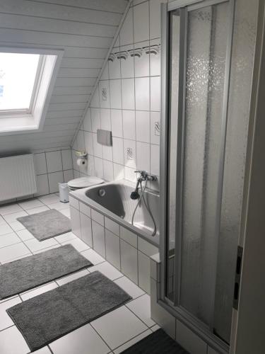 a bathroom with a shower and a bath tub at Gaestehaus Savo in Nürburg