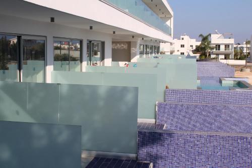 a row of purple tiles on the side of a building at Fedrania Gardens Hotel in Ayia Napa