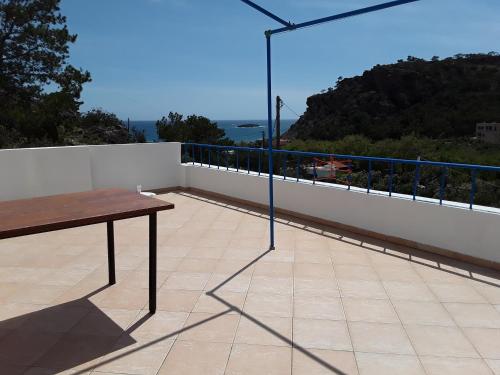 a table on a balcony with a view of the ocean at Aaron Studios Apartments in Agia Fotia