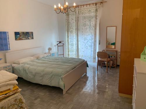 a bedroom with a large bed and a desk at Casa Formis in Levanto