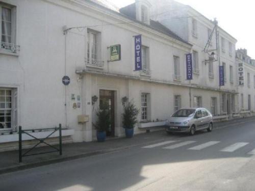 a white building with a car parked in front of it at La Tete Noire in Montrichard