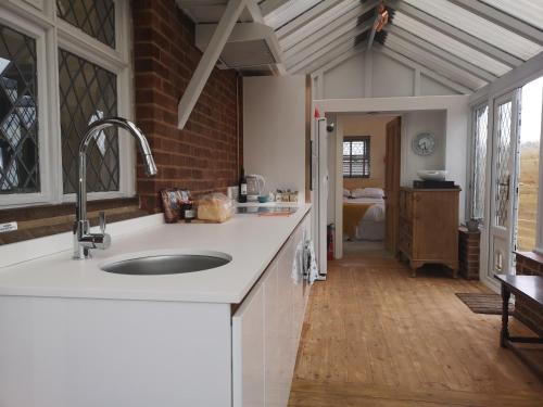 a kitchen with a sink and a counter top at Paygate Cottage Brenchley in Brenchley