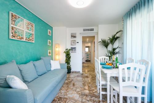 a living room with a blue couch and a table at Apartamento AGUA MARINA Levante Beach in Benidorm