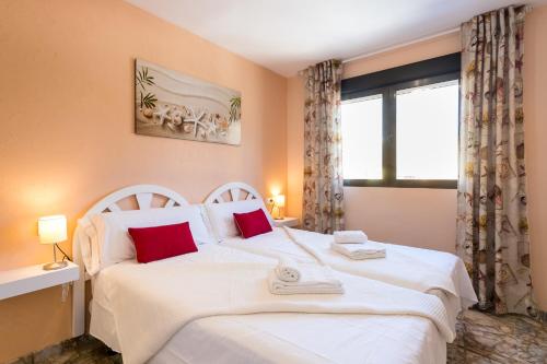 a bedroom with two beds and a window at Apartamento AGUA MARINA Levante Beach in Benidorm