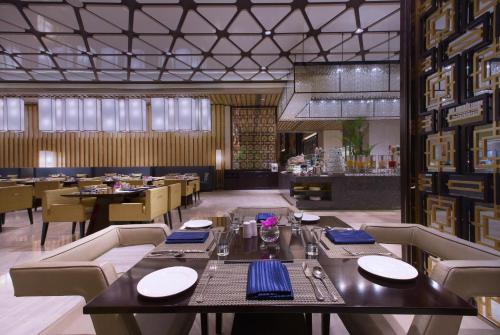 a dining room with a table and some chairs at Wanda Vista Taiyuan in Taiyuan
