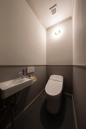 a small bathroom with a toilet and a sink at UNWIND HOTEL & BAR OTARU in Otaru