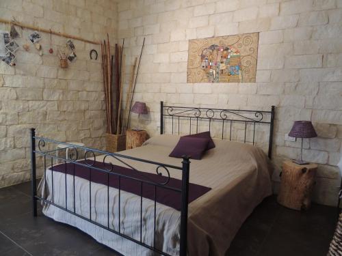 a bedroom with a bed with a metal bed frame at Monolocale l'Abbraccio in Ragusa