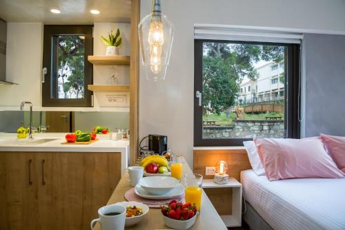 een kamer met een bed en een tafel met eten erop bij Nest of Marmel Luxury Studio in Chania