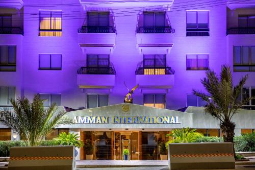 a hotel with a purple facade at Amman International Hotel in Amman