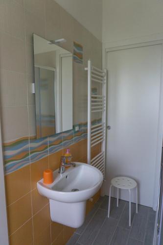 a bathroom with a sink and a mirror at B&B Casa di Mimma in Montesilvano
