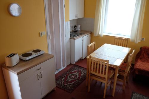 a small kitchen with a table and a dining room at Apartmán Marta in Staré Splavy