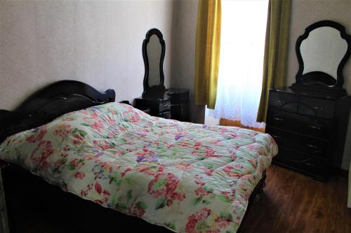 a bedroom with a bed and a dresser at Guesthouse Medea on Pushkini 4 in Kutaisi