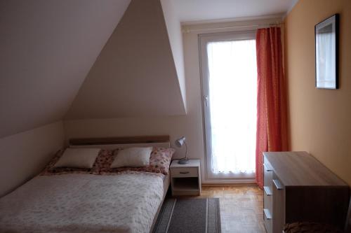 a bedroom with a bed and a large window at Apartmán Marta in Staré Splavy