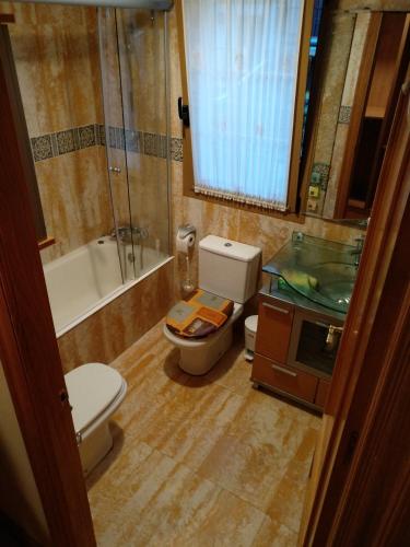 a bathroom with a toilet and a sink and a tub at Bordatxiki in Hondarribia