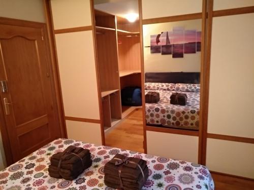 a bedroom with a bed and a mirror and a closet at Bordatxiki in Hondarribia