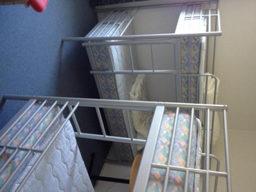 a room with a bunk bed with metal shelving at Hotell Angöringen in Karlskrona
