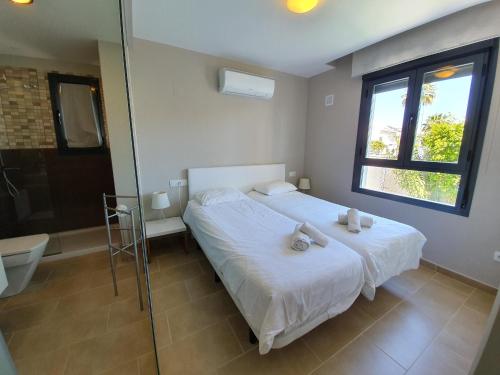 a bedroom with a bed and a glass shower at Eva's Place Villamartin VM052 in Villamartin