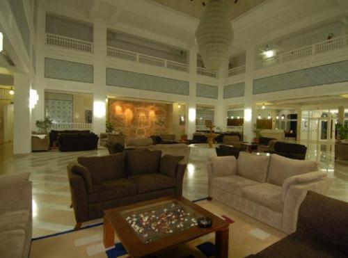 a large living room with couches and a table at Yadis Hammamet in Hammamet