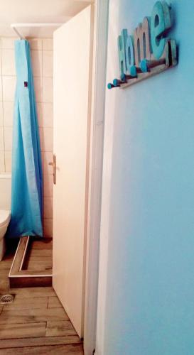 a bathroom with a toilet and a door with the word home at Polymnia's apartment in Matala