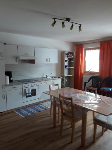 a kitchen with a wooden table and a dining room at Hofstatthof in Campo di Trens